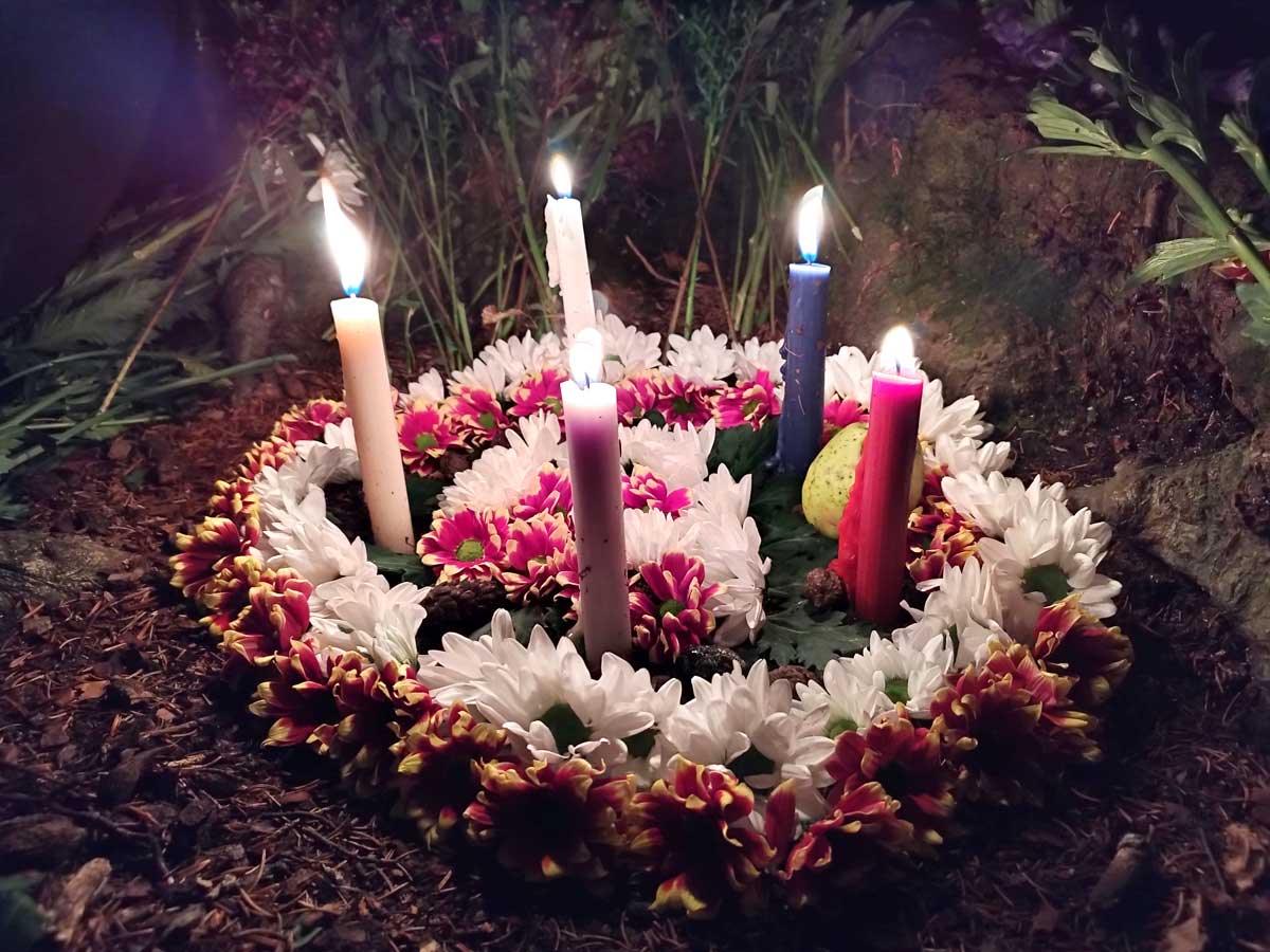 Blumenkranz mit brennenden Kerzen - Altar